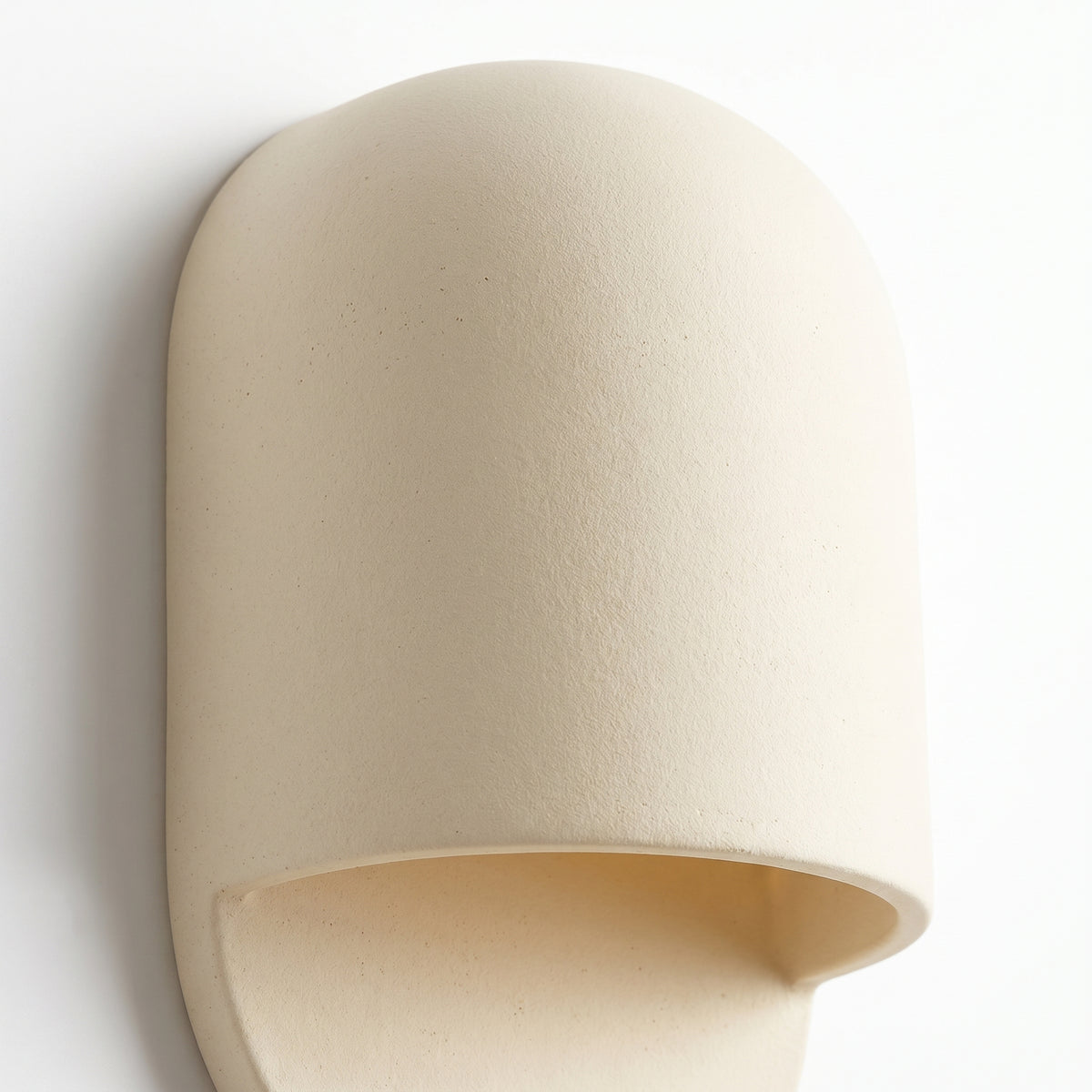 Close-up of the AX472 white ceramic wall sconce showing its matte speckled glaze and curved hood