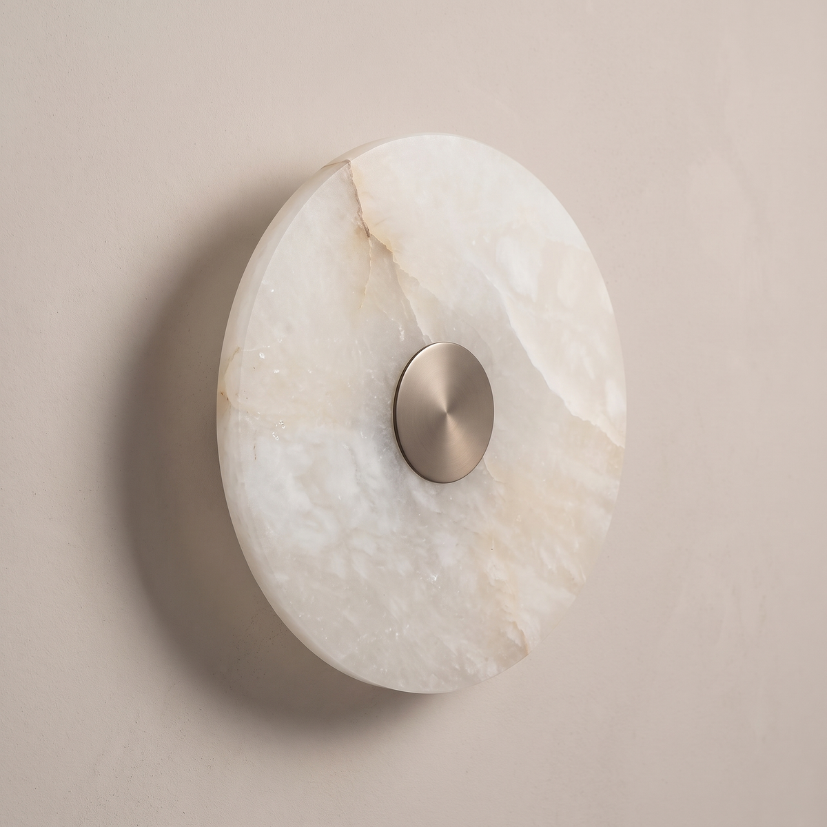 AX318 round alabaster wall light at a slight angle, showing natural stone veining on a plaster wall