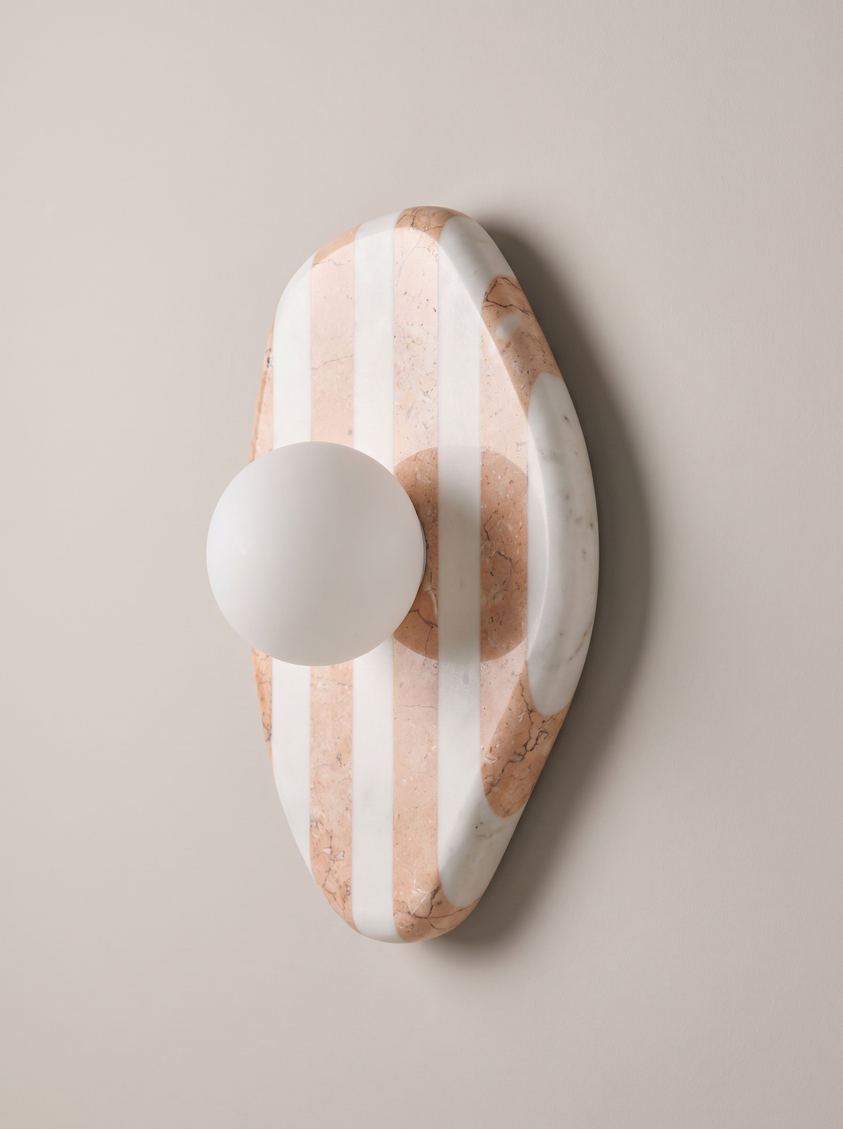 Sculptural wall sconce AX200, organic striped marble backplate and white glass globe sconce